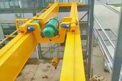 Double girder overhead crane with customized electric hoist trolley frame, placed between the two girder 