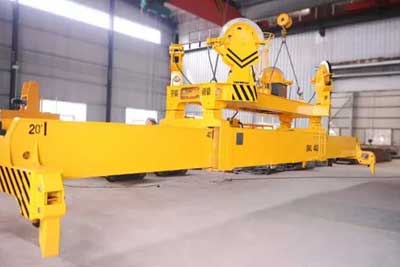 Container spreader for rail mounted gantry crane 