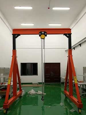 Adjustable gantry crane with manual hoist